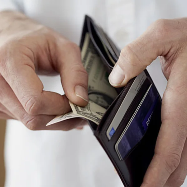 person opening wallet and pulling out cash